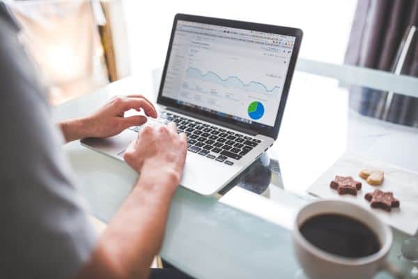 Laptop on desk with growth charts
