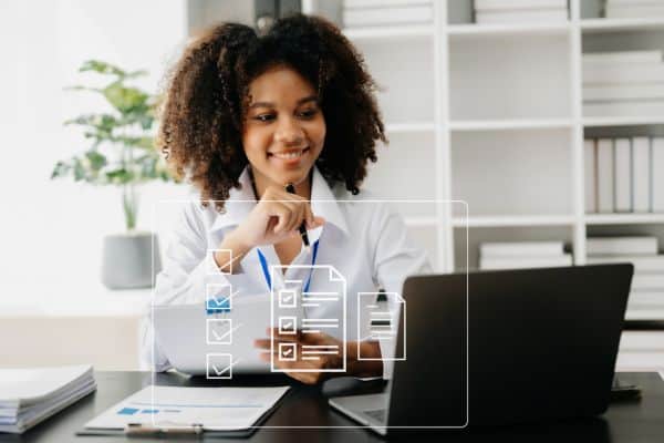 Woman at desk with laptop and virtual checklist